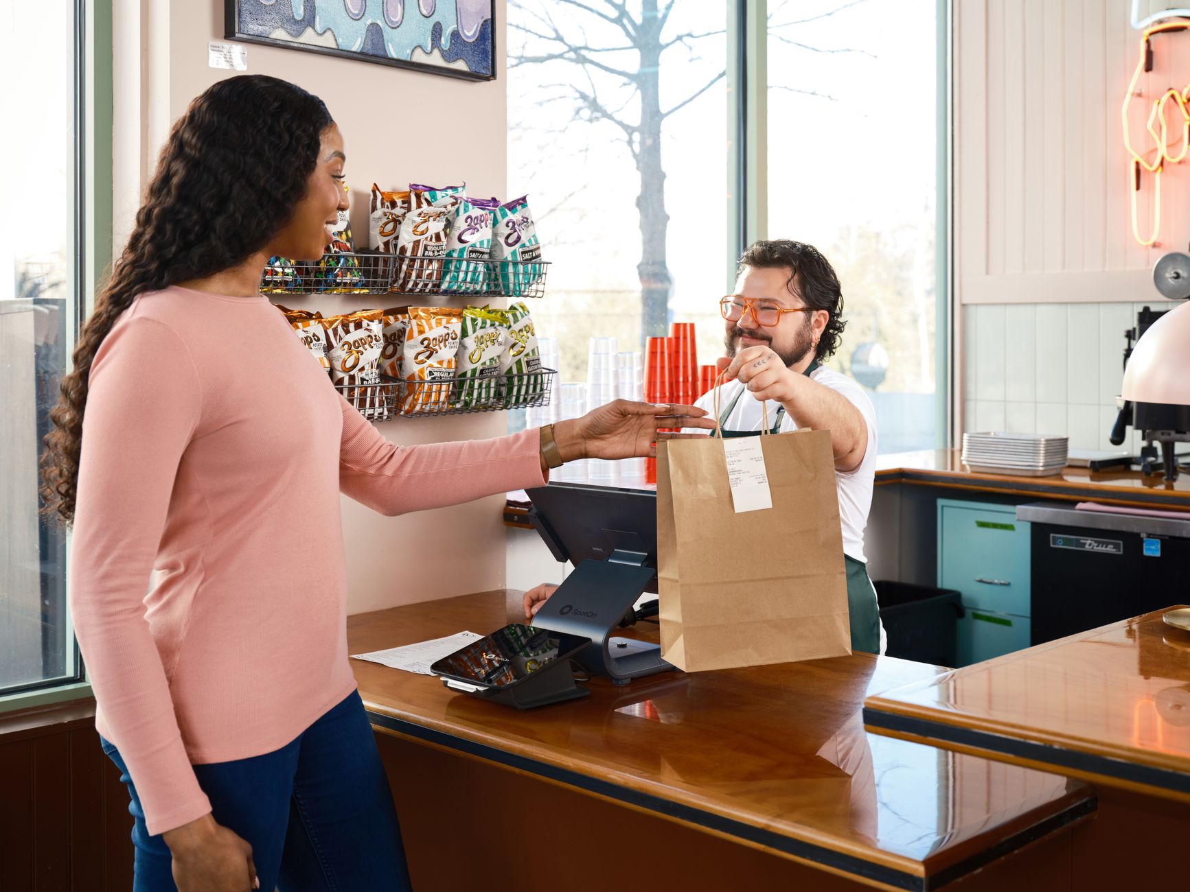 Customer support team coordinating online orders and communicating with customers in a modern office