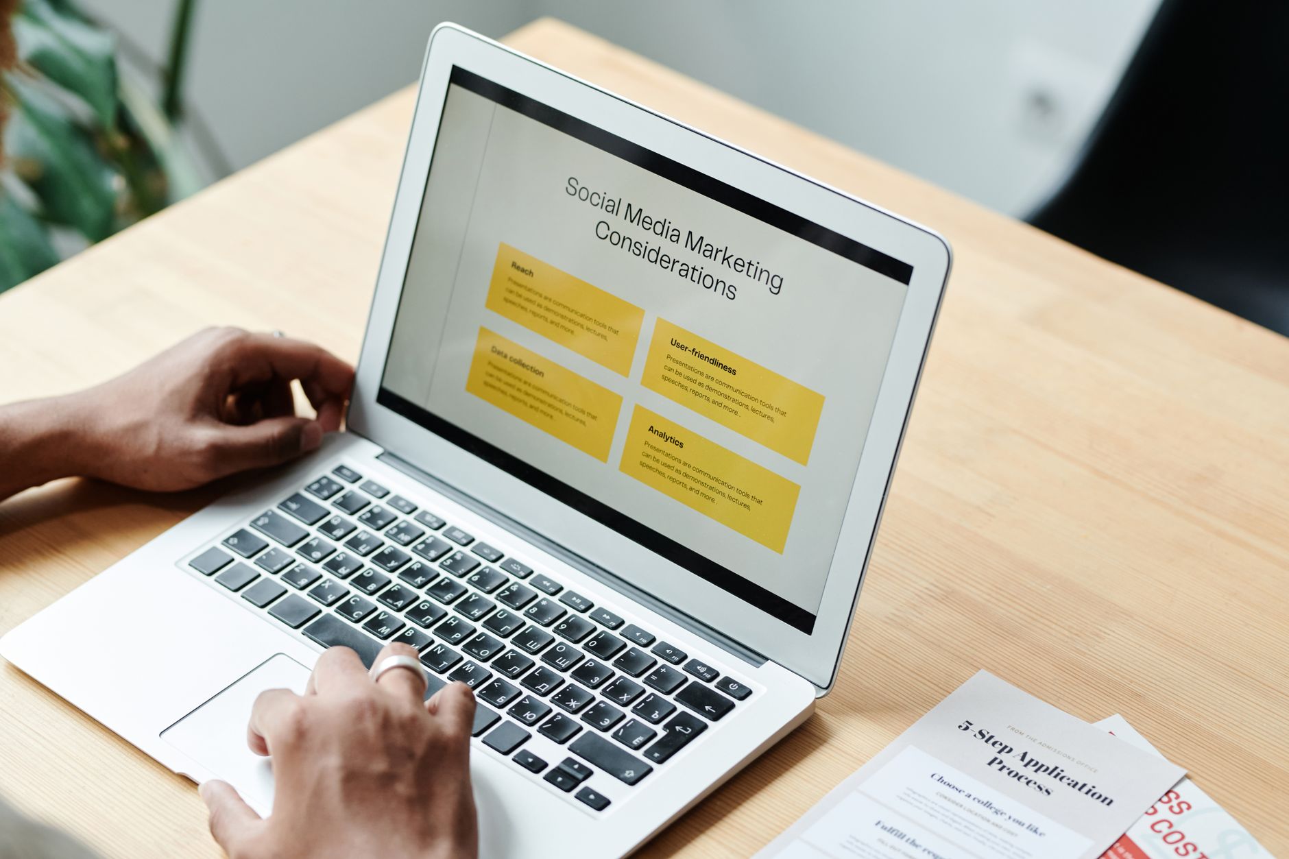 Marketer reviewing online content and planning social media distribution on a computer