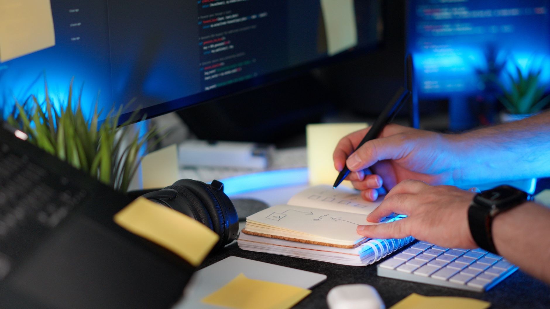 Person planning a website on a laptop at a desk, representing the process of choosing a WordPress blog theme.
